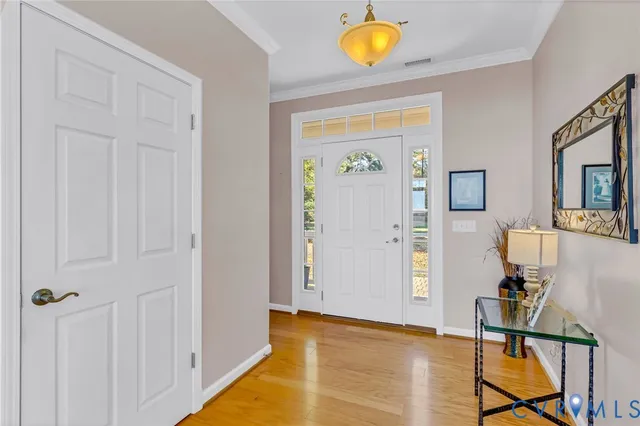 a view of a livingroom with wooden floor and furniture