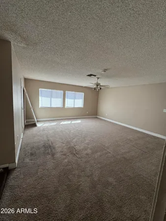 an empty room with an empty space and windows