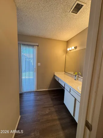 a view of a kitchen with wooden floor and staircase