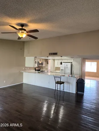 a view of a dining room with furniture a chandelier and wooden floor