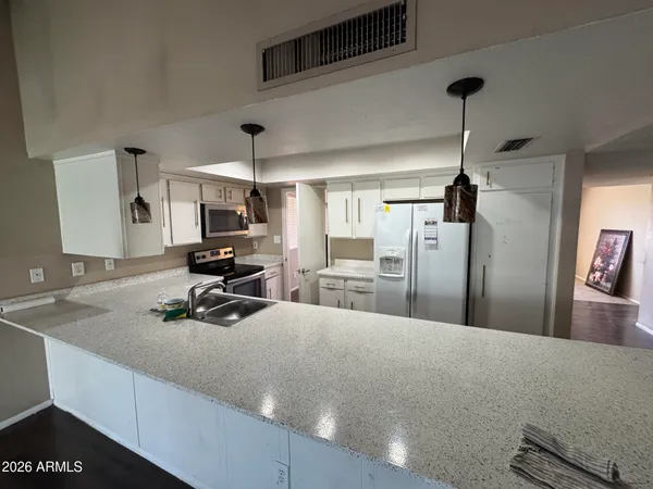 a kitchen with a refrigerator a stove and a sink
