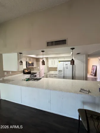 a living room with stainless steel appliances kitchen island granite countertop furniture and a kitchen view