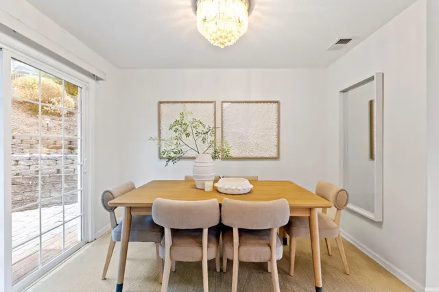 a dining room with furniture and a window