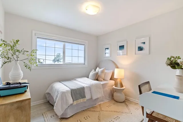 a bedroom with a bed and a window