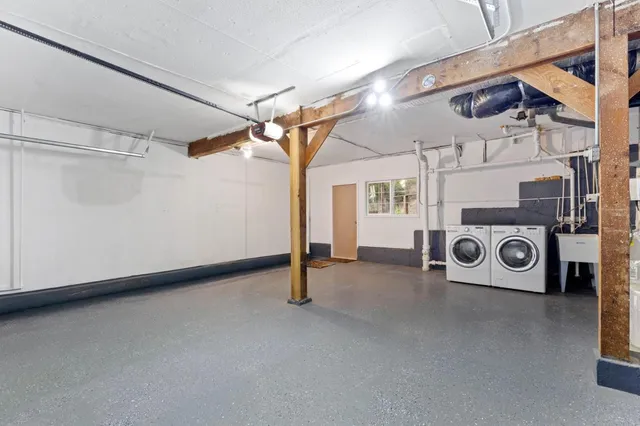 a view of a storage and utility room with washer and dryer