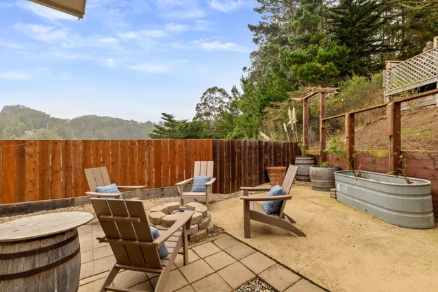 a view of a patio with a table and chairs