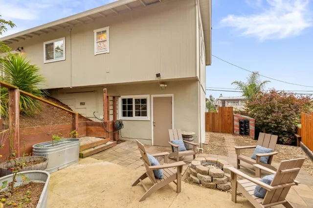 a view of a patio with couches table and chairs and potted plants