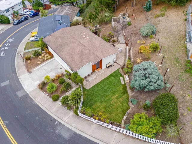 an aerial view of a house a garden and swimming pool