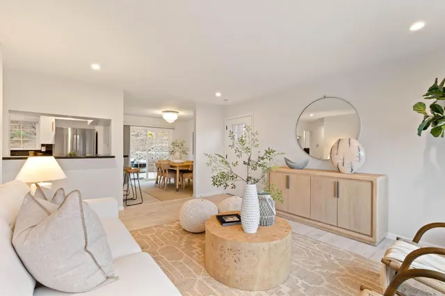 a living room with furniture a fireplace and chandelier