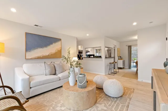 a living room with furniture and kitchen view