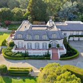 an aerial view of a house with swimming pool garden and patio