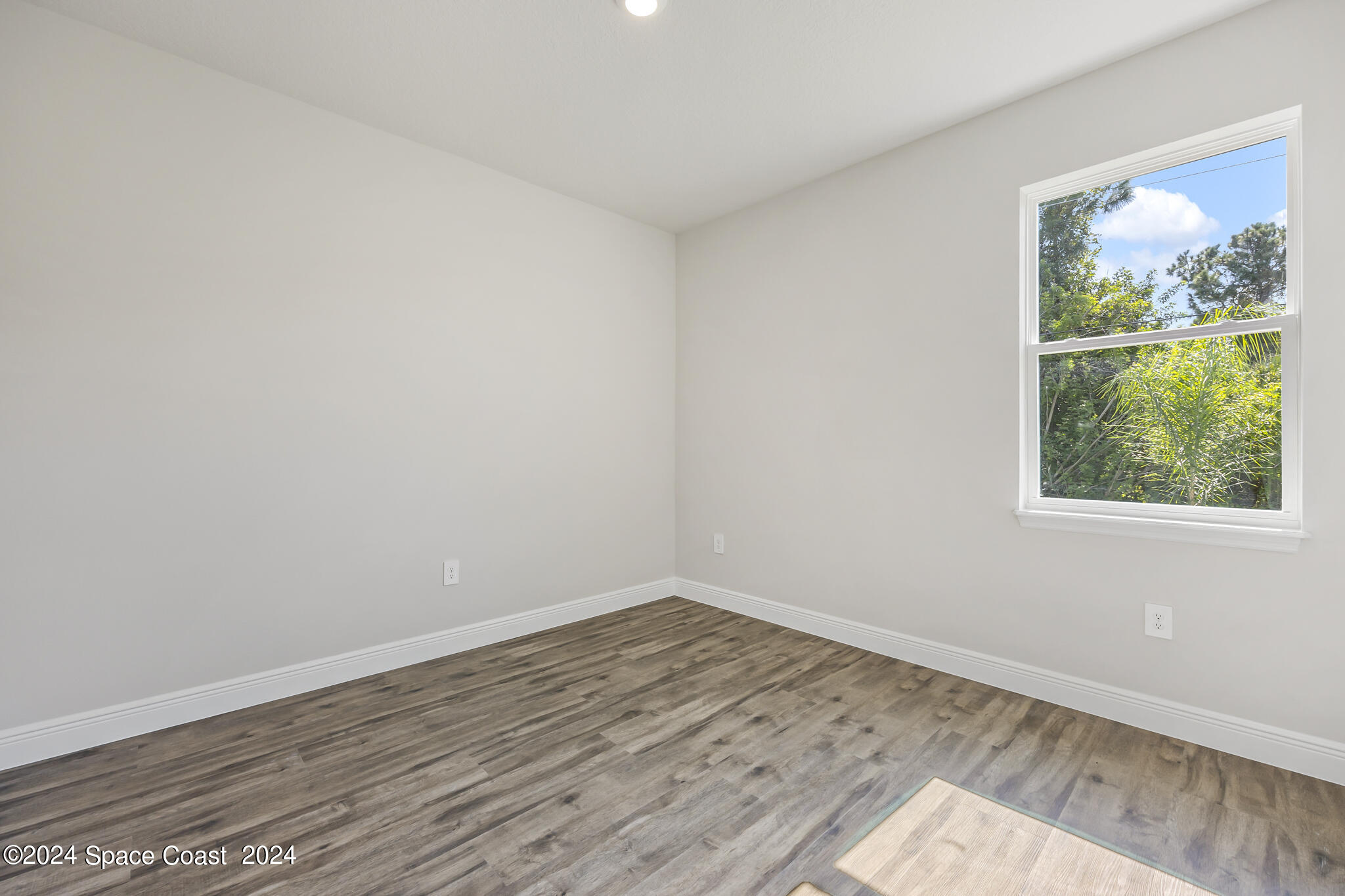 1368 Rabbit Street Southeast Palm Bay, FL 32909 - Photo 20 of 31 wooden floor in an empty room with a window