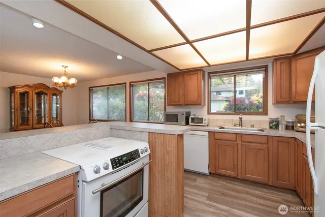 a kitchen with lots of counter top space and wooden floor