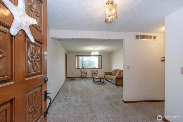 a view of an entryway with wooden floor