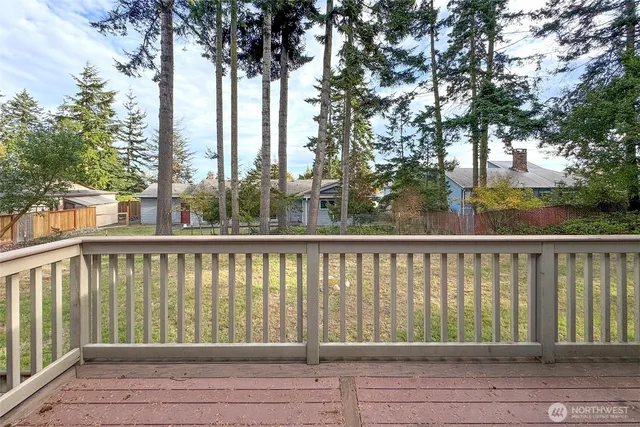 a view of balcony with wooden floor and seating space