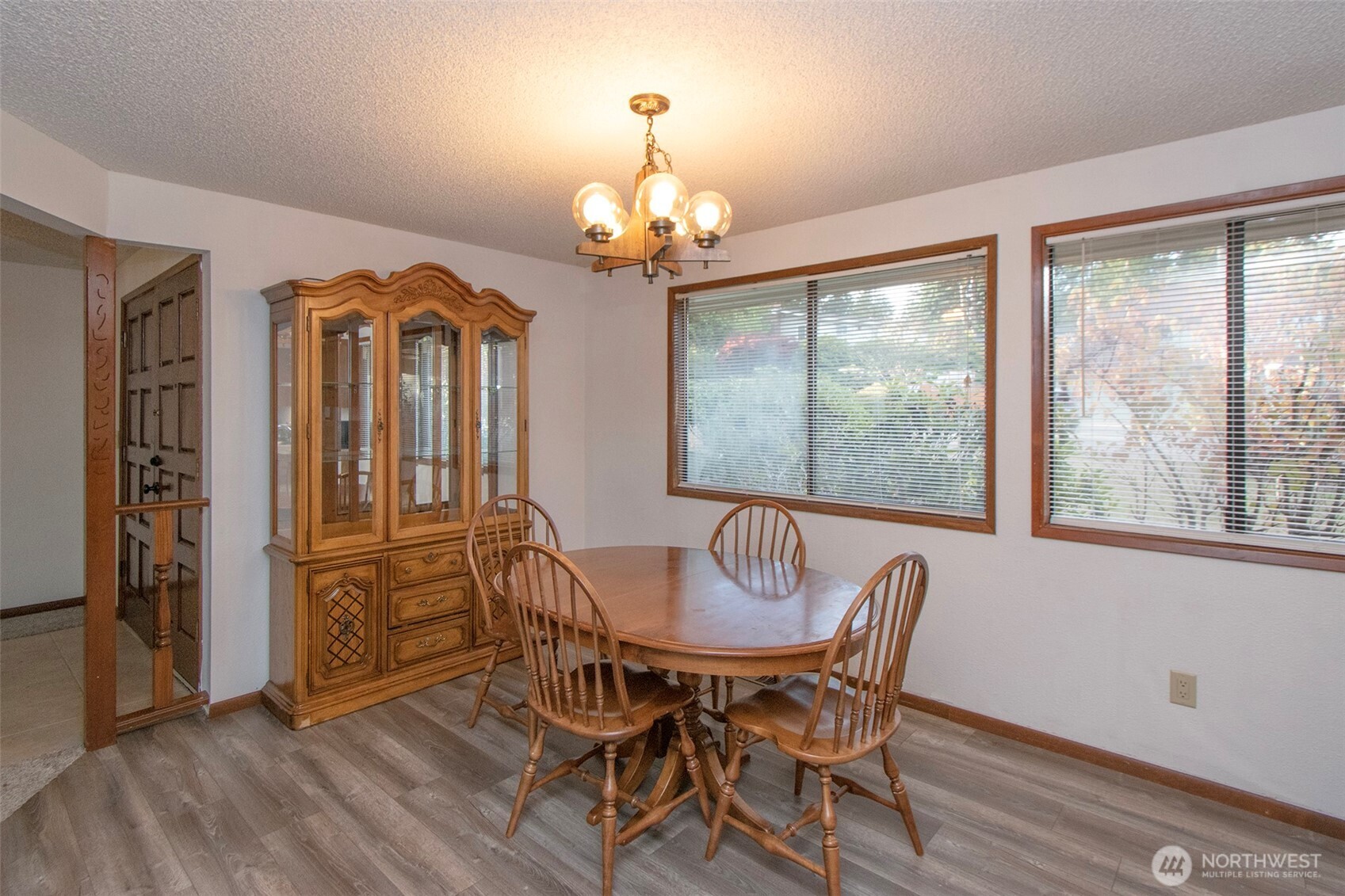2131 West 7th Street Port Angeles, WA 98363 - Photo 6 of 40 a view of a dining room with furniture a chandelier and wooden floor