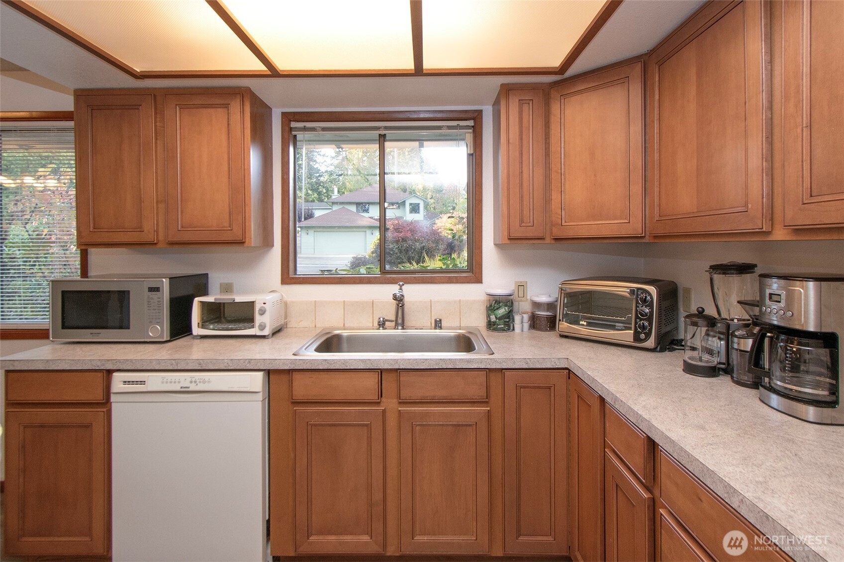 2131 West 7th Street Port Angeles, WA 98363 - Photo 10 of 40 a kitchen with stainless steel appliances granite countertop a sink a stove and cabinets