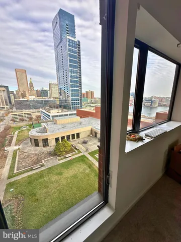 a view of balcony with a couple of cars parked on road