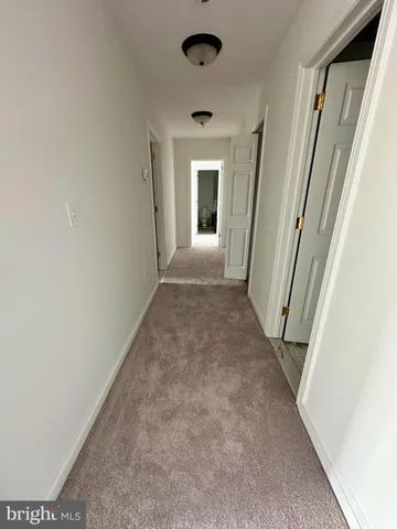 a view of empty room with a fireplace