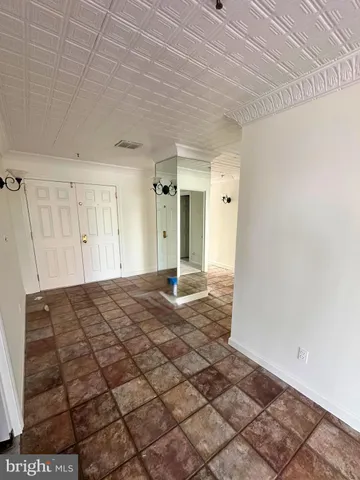 a kitchen with a refrigerator and cabinets