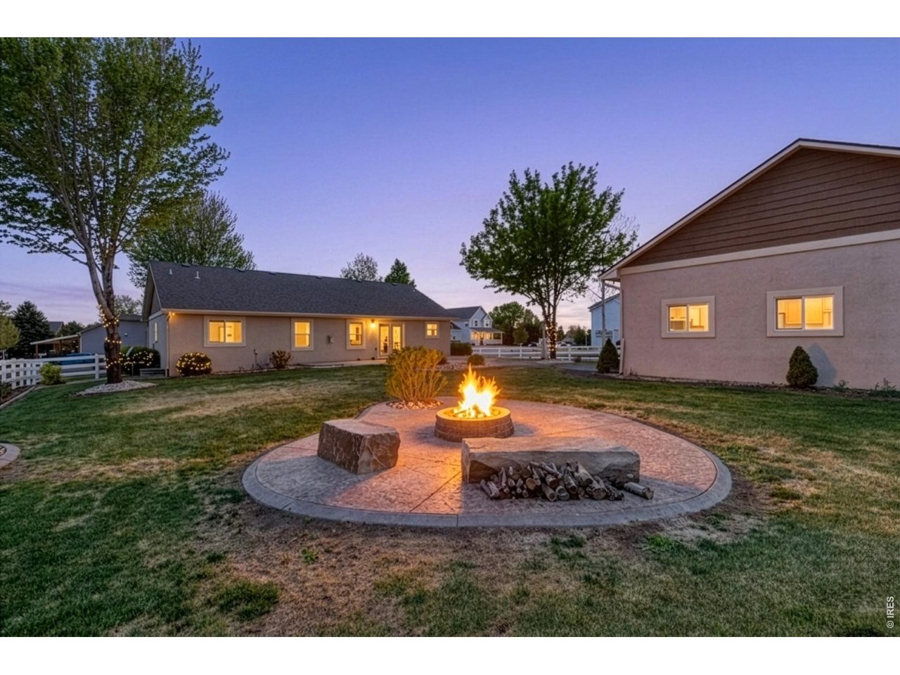 2002 Trail Ridge Drive Severance, CO 80615 - Photo 2 of 50 The backyard is built for enjoying Colorado living with mature trees, a spacious 550 sq ft stamped patio, and a dedicated firepit area perfect for entertaining on summer evenings.
