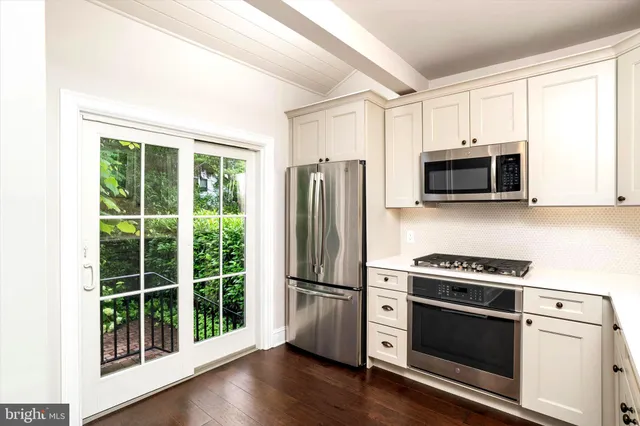 a kitchen with stainless steel appliances a stove a microwave and a refrigerator