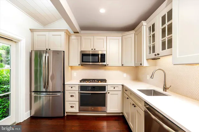 a kitchen with a refrigerator sink and microwave