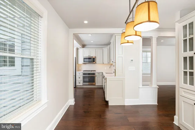 a view of a kitchen with a refrigerator and microwave
