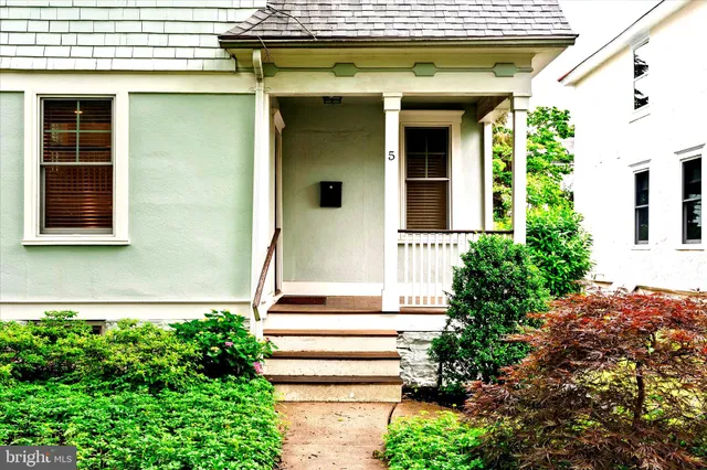 a front view of a house with plants