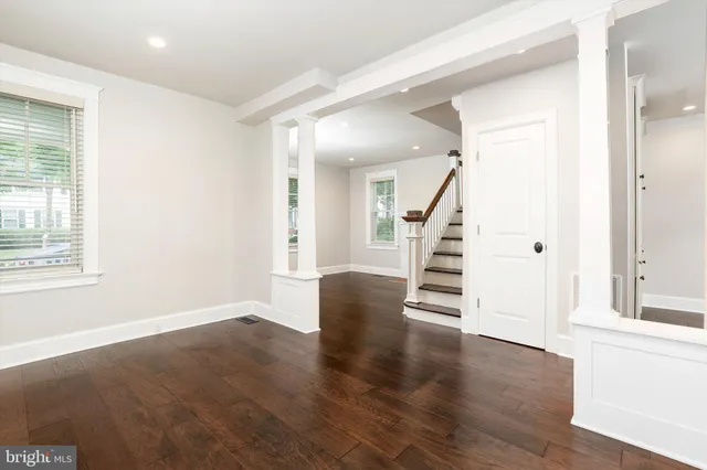 a view of an entryway with wooden floor and stairs
