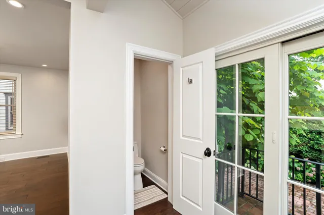 a view of a room with wooden floor and windows