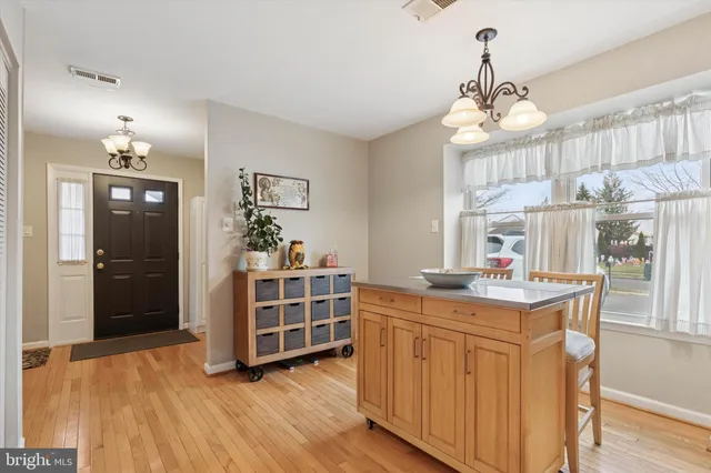 a dining room with furniture and chandelier