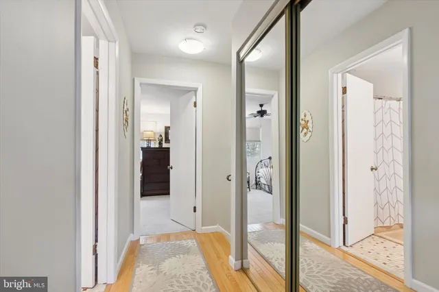 a bathroom with a granite countertop toilet a sink and a mirror