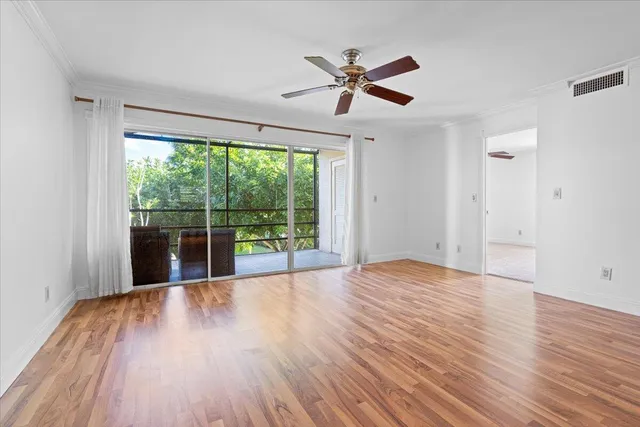 a view of room with wooden floor and fan