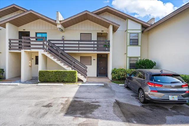 a car parked in front of white house