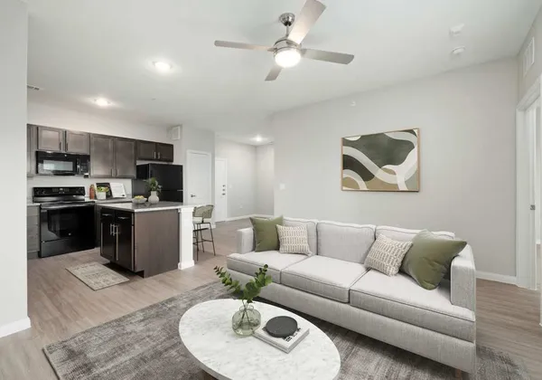 a living room with furniture kitchen and a chandelier