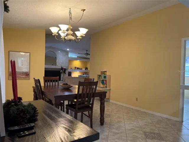 a view of a dining room with furniture and chandelier