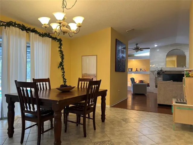 a view of a dining room with furniture and chandelier