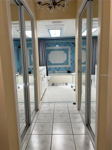 a bathroom with a tub shower and mirror