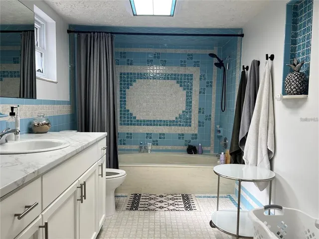 a bathroom with a sink a toilet and a bathtub