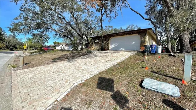 a view of a house with a yard covered in snow