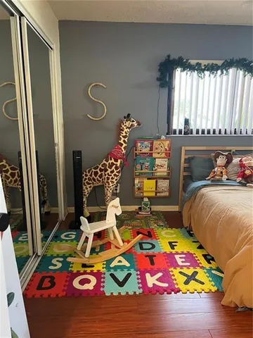 a bedroom with bed and a window