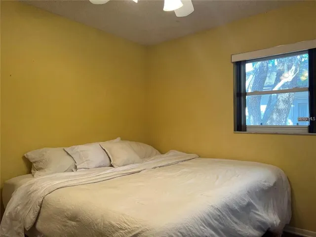 a bedroom with a bed and a window