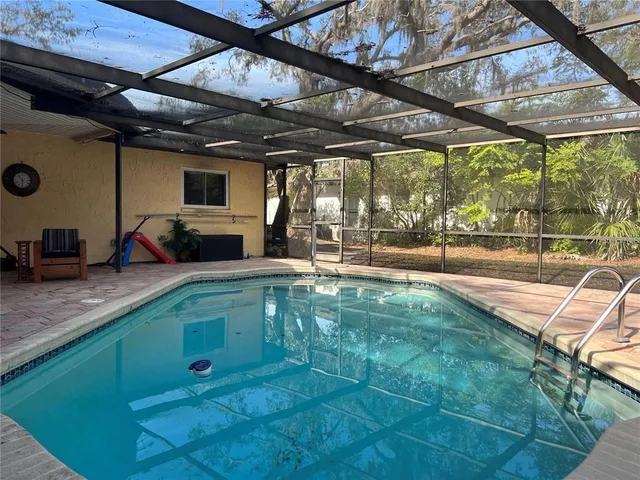 a view of a swimming pool with a patio