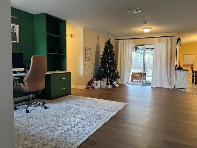 a view of workspace with wooden floor windows