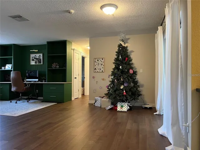 a living room with hard wood floors and a window