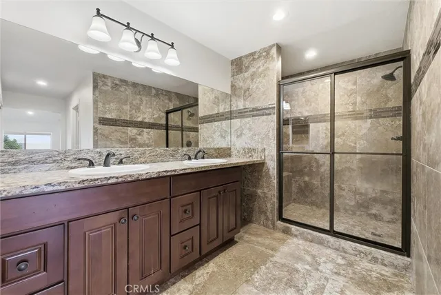 a bathroom with a granite countertop sink mirror and double