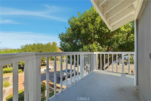 a balcony with trees in front of it
