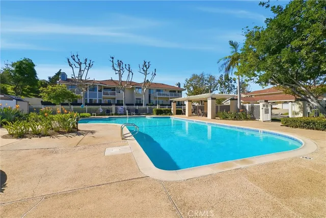 swimming pool view with plants and large trees