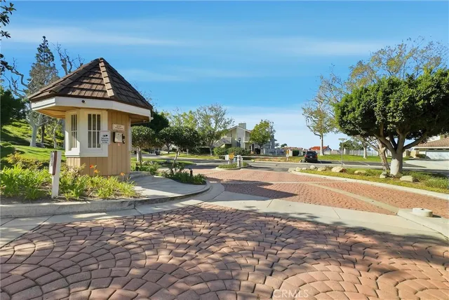 a view of a white house with a yard and potted plants
